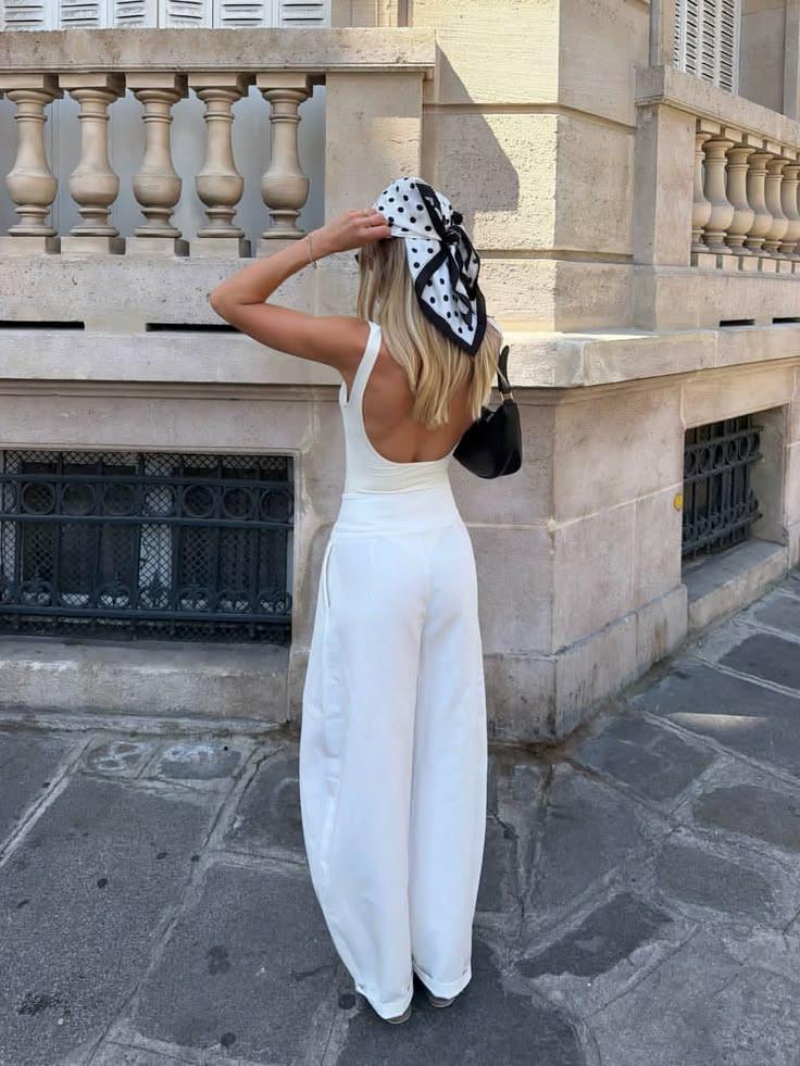 Woman in white trousers and a polka-dot headscarf in Paris