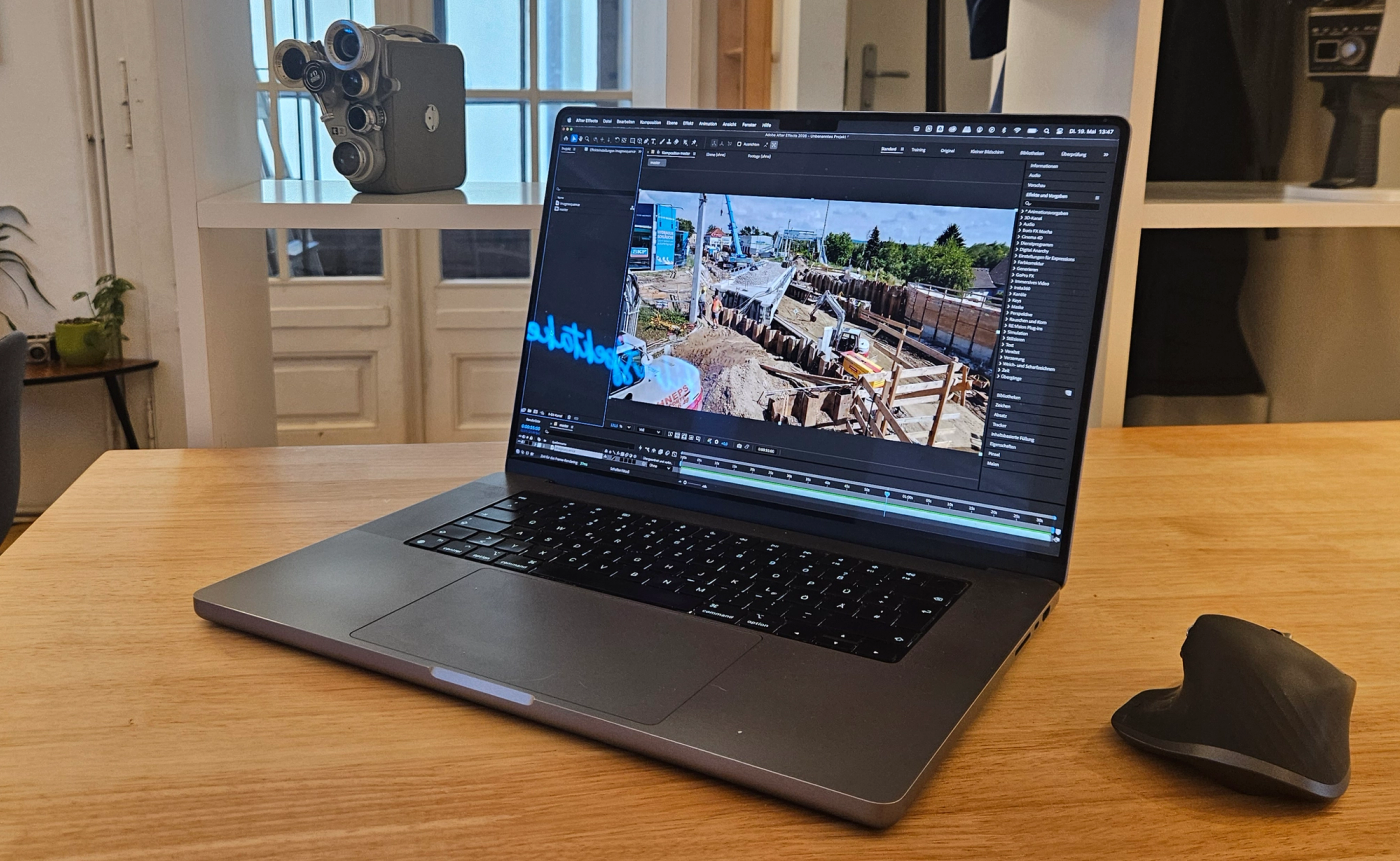 Professional construction timelapse video editing workflow on a laptop