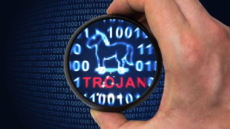 Hand holding a magnifying glass over binary code, revealing a Trojan horse icon and the word "TROJAN" in red.
