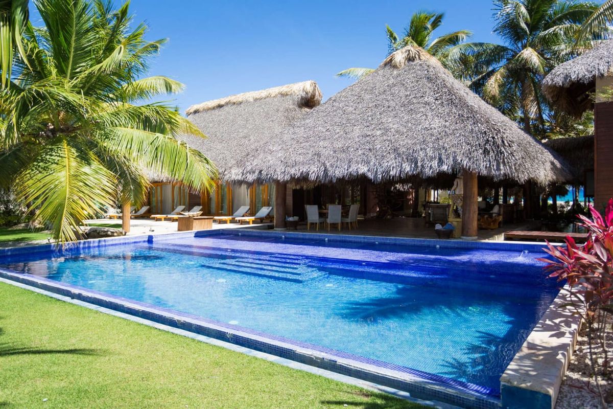 Private pool on the villa's lawn beside the thatched terrace, facing the sea