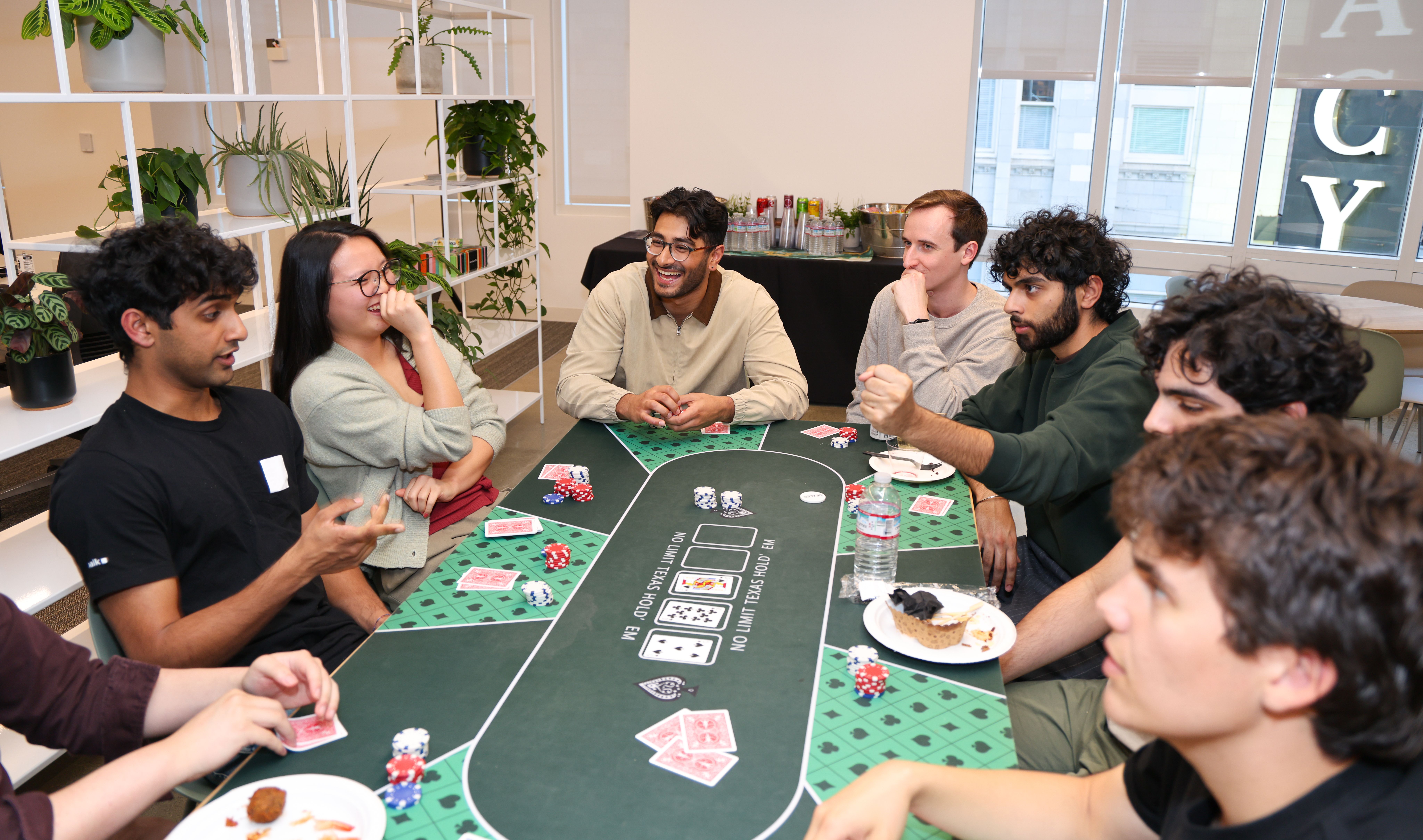 Office warming guests playing poker. Mahjong was also played.