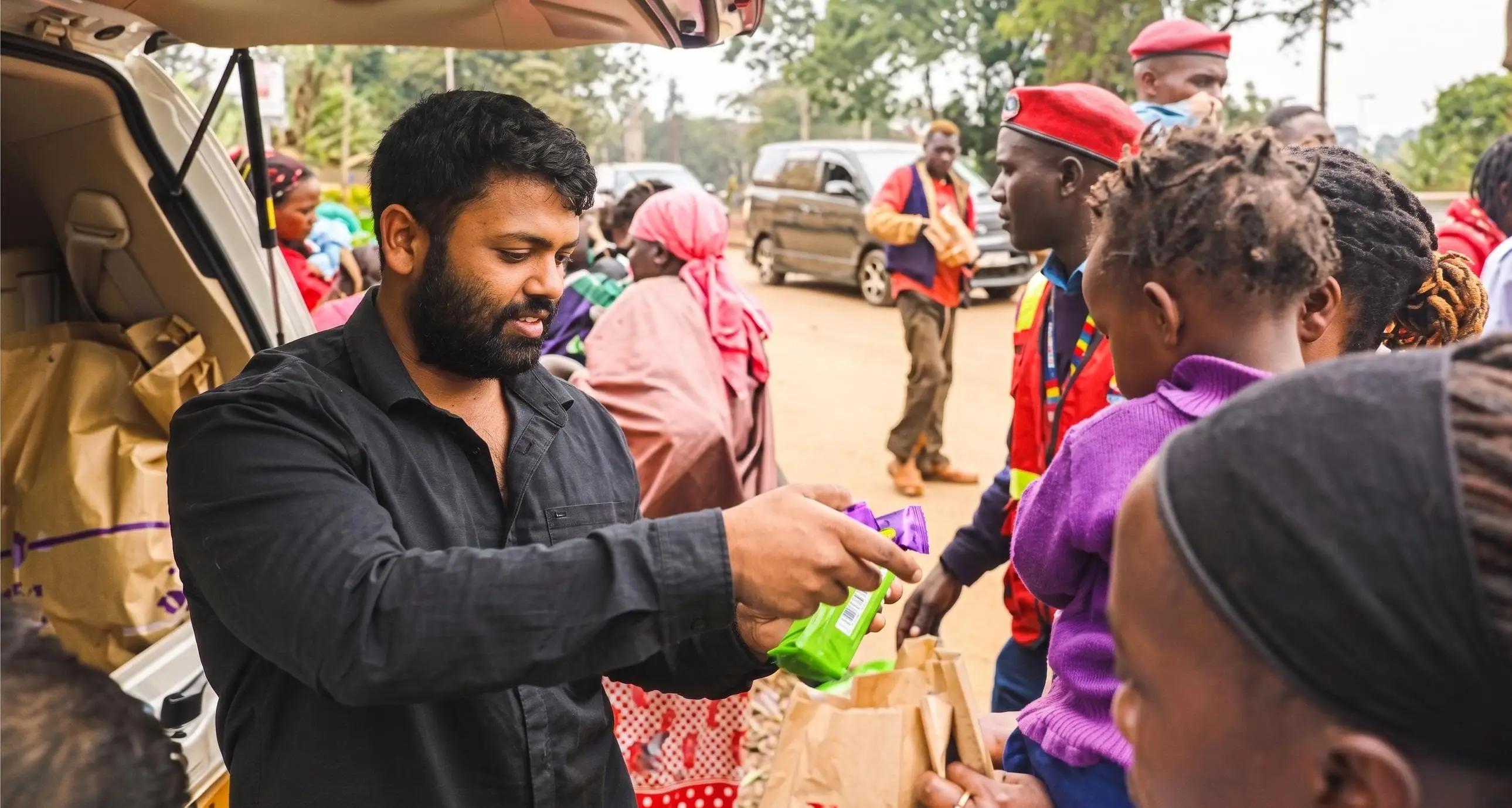 Ishan Shivanand distributing supplies during a rural community outreach program