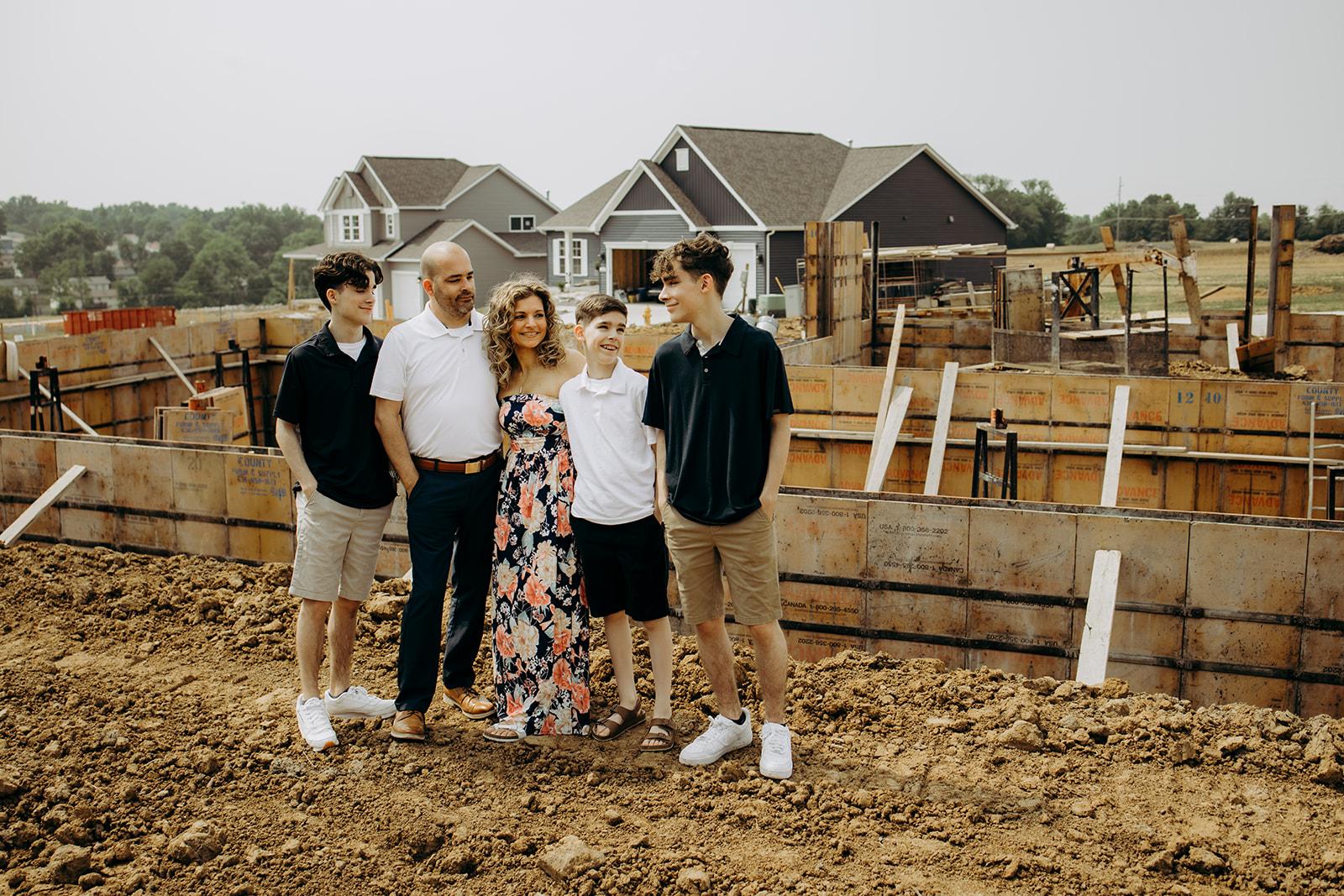 Family standing in front of an under construction home from Gentry homes