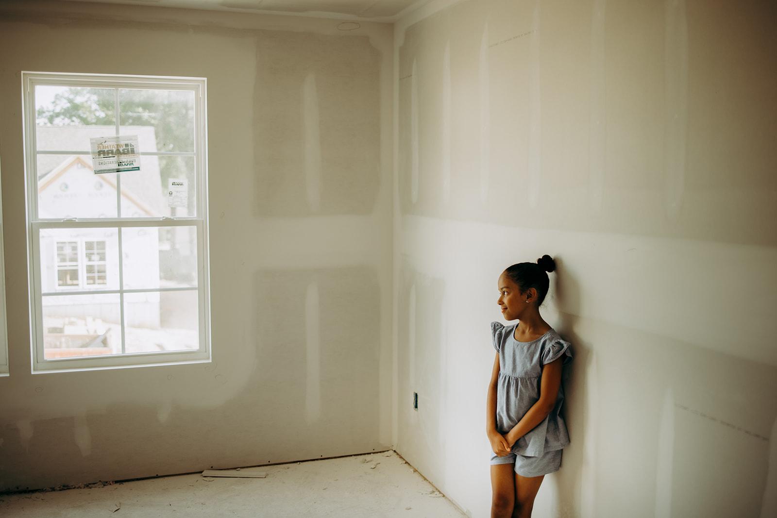 Girl standing in an under construction home from Gentry Homes