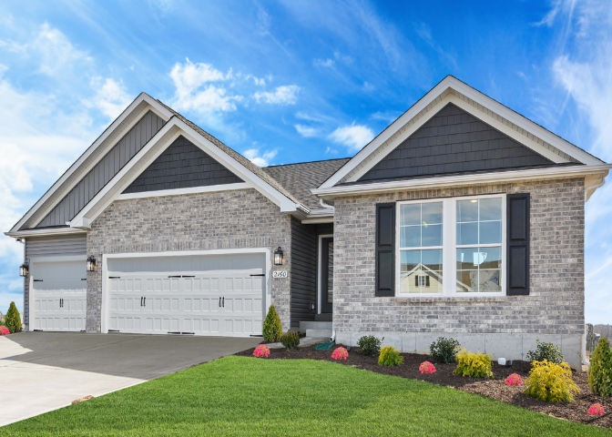Modern Gentry Homes single-story brick house with a three-car garage, manicured landscaping, and a vibrant green lawn under a bright blue sky in an Iowa community.