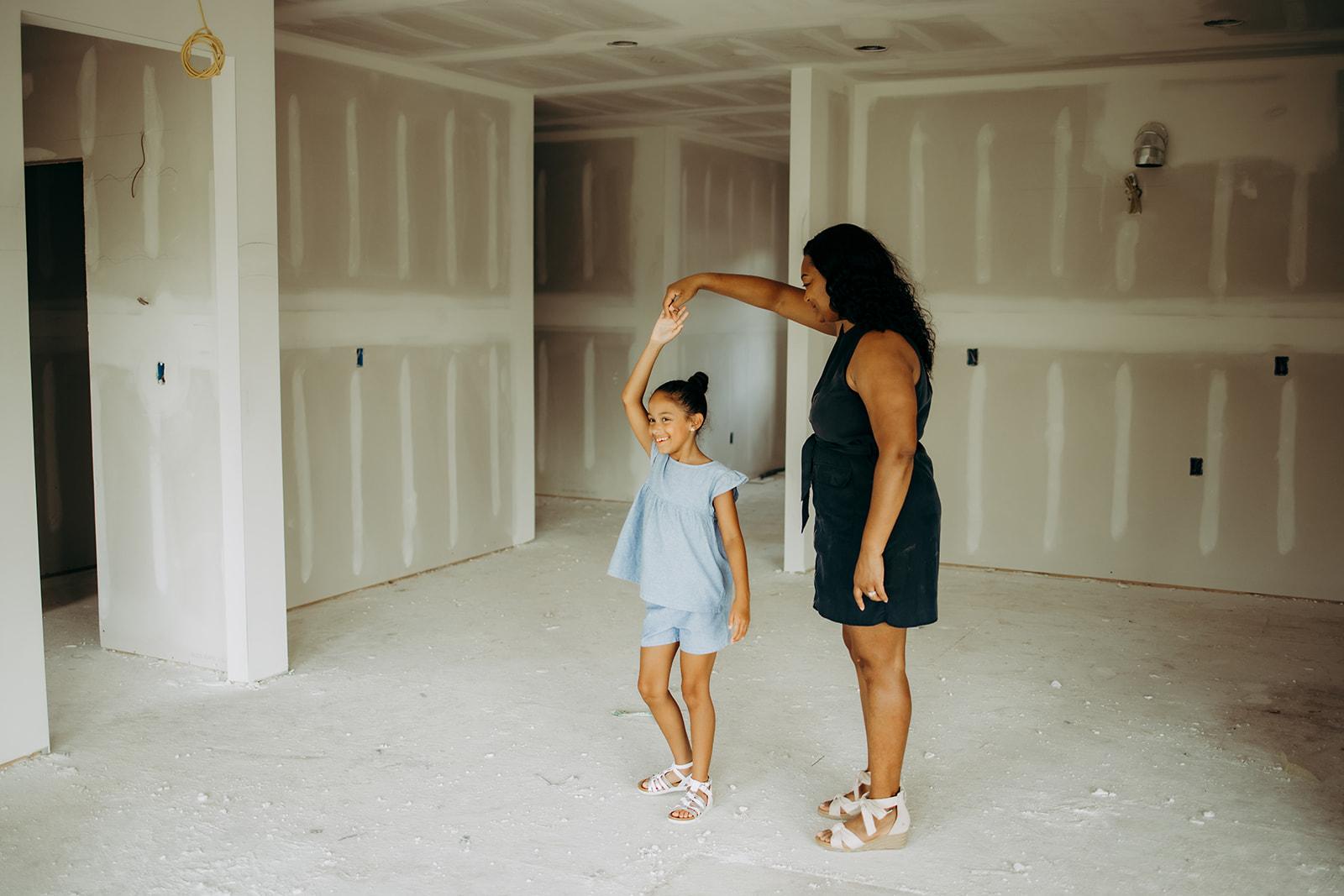 Mother and daughter standing in an under construction home from Gentry Homes
