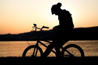 boy sits on bicycle