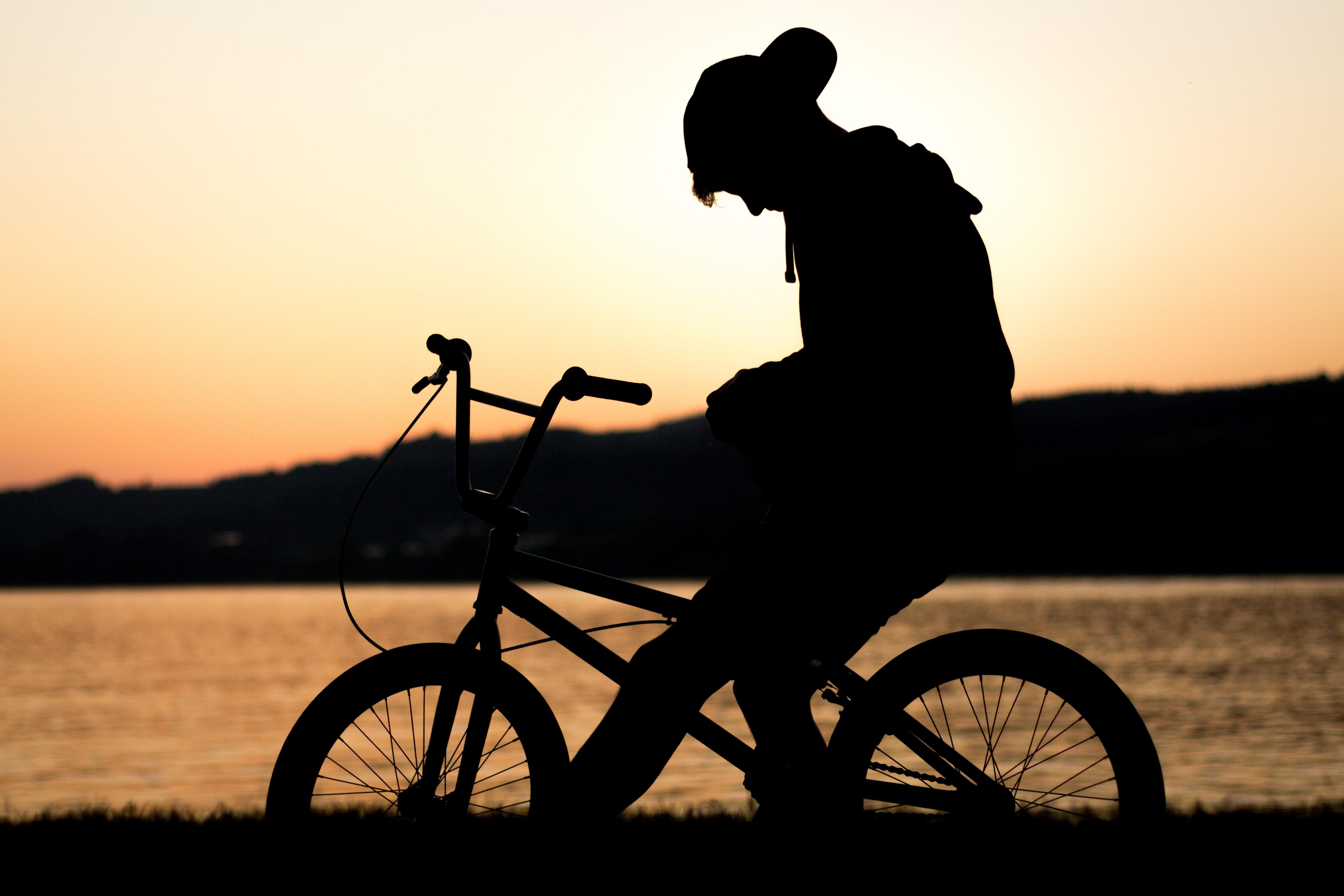 boy sits on bicycle