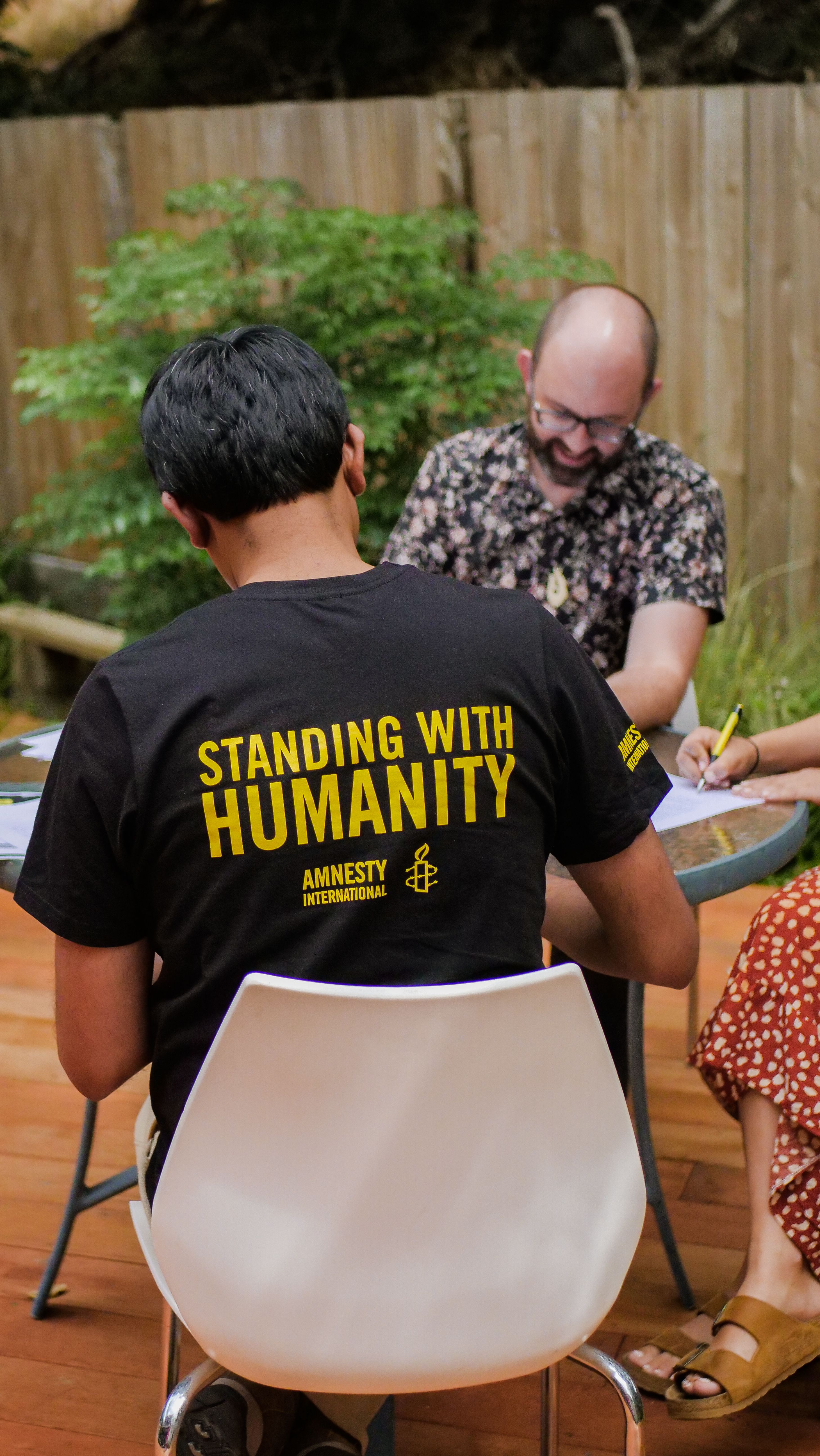 People sitting at a table in a garden