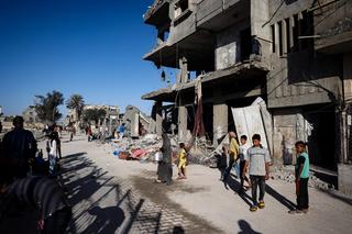 Palestinians salvage belongings from the rubble of a building hit by overnight Israeli bombing in Rafah