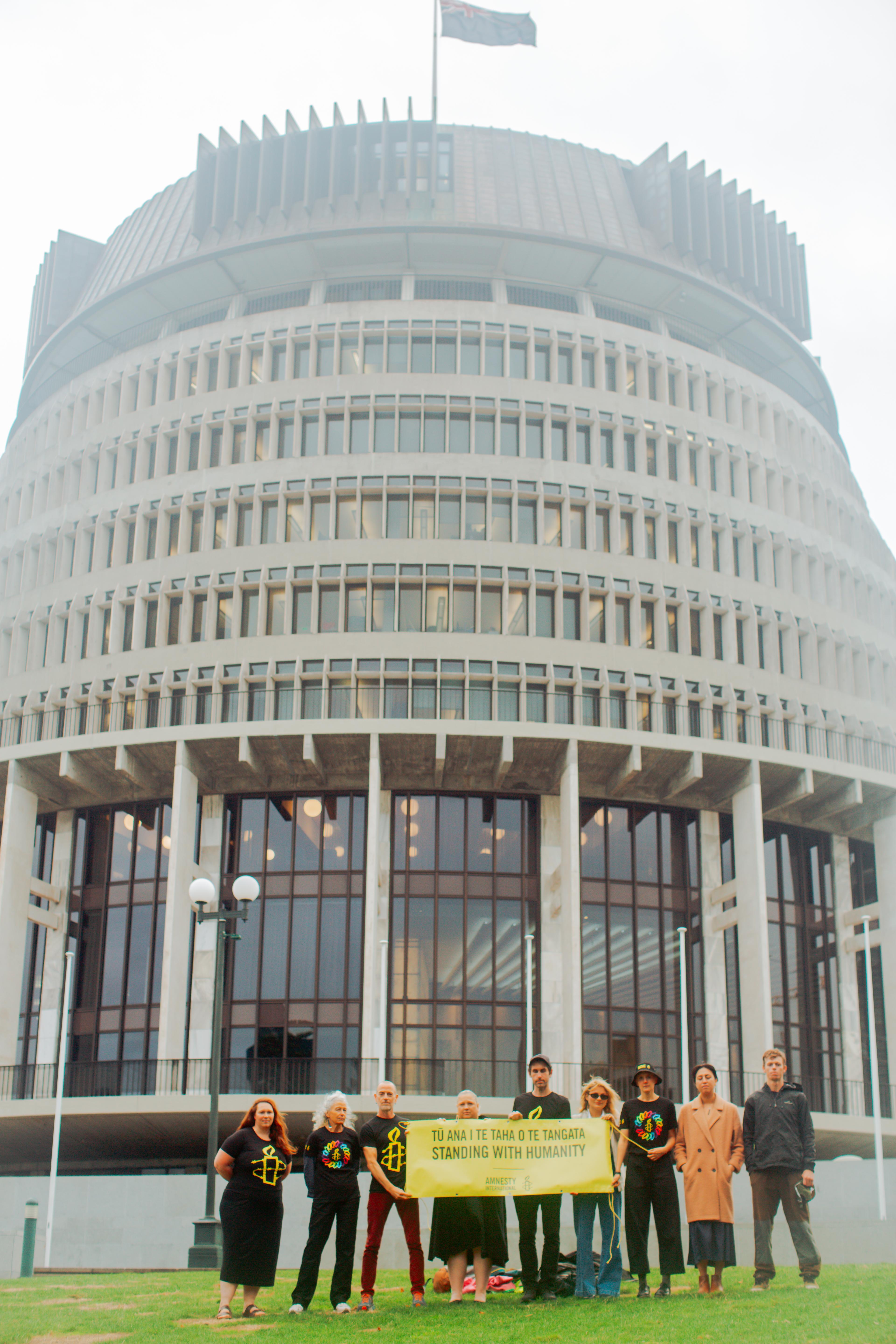 Amnesty supporters stand in front of NZ Parliament