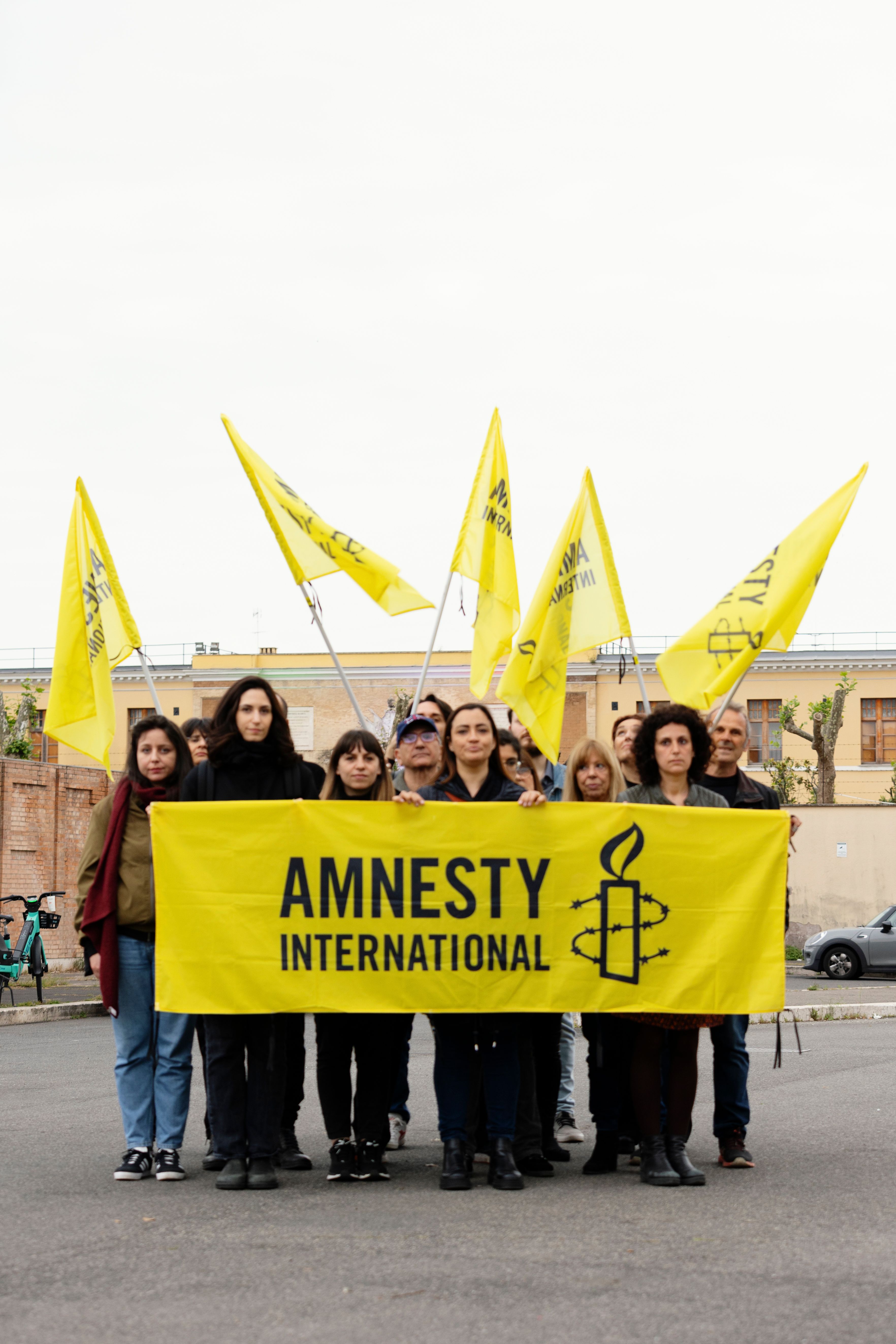 Group of people hold Amnesty International banner