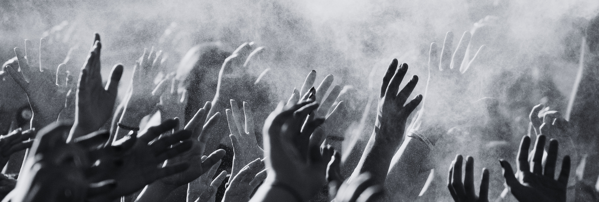 a group of hands in the air waving from side to side
