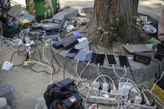 A view of phones being charged by portable charging stations at Palestinian Red Crescent center as people experience electricity shortages after Israeli attacks in Khan Yunis, Gaza