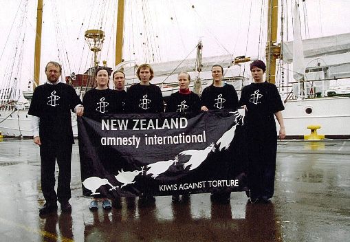 Amnesty International New Zealand members campaigning against torture in front the Esmaralda ship in Wellington