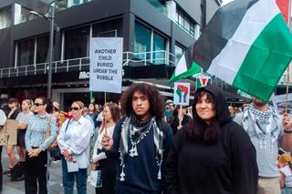 two people stand in a protest calling for a ceasefire in Gaza