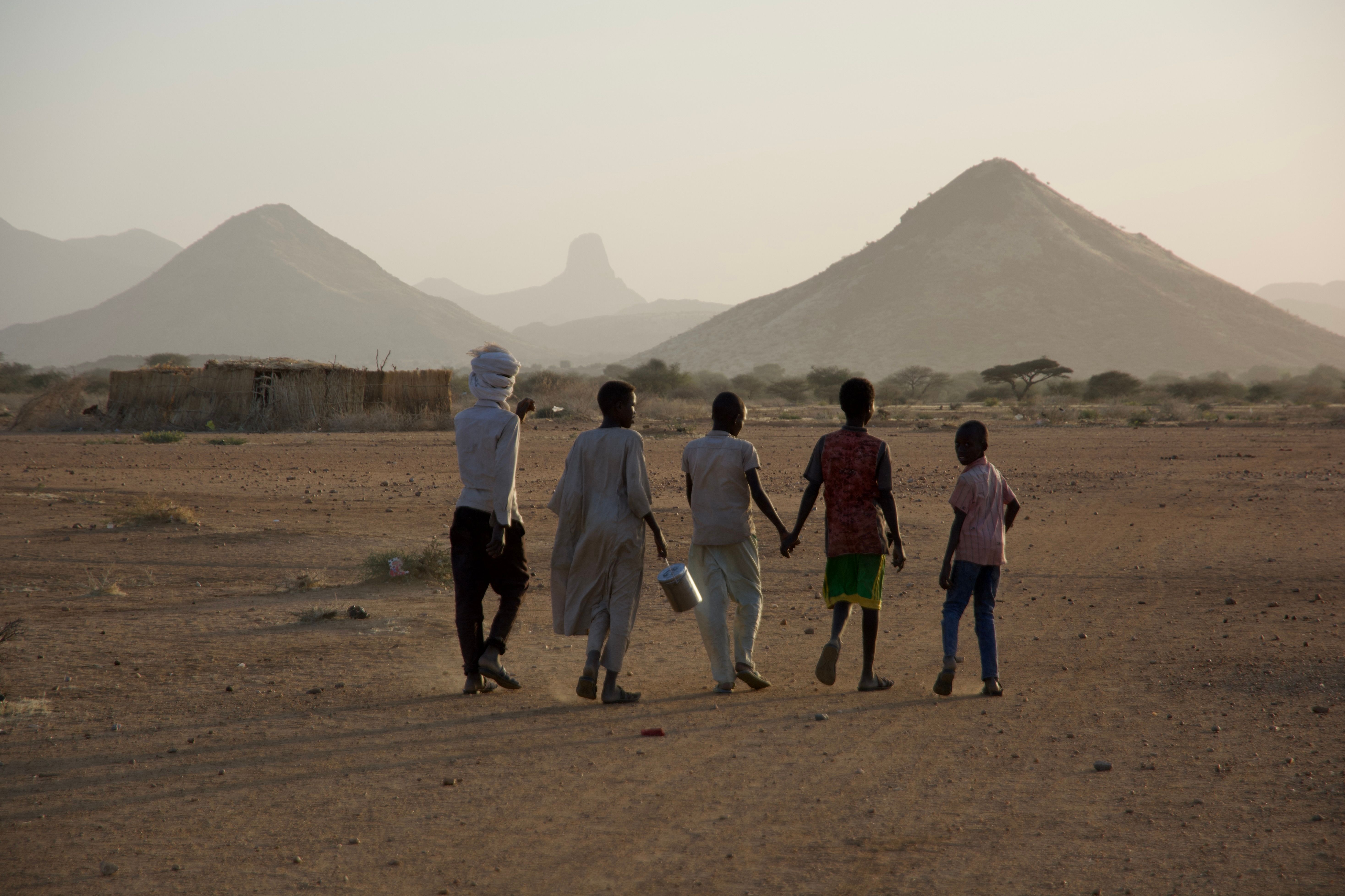 Sudanese children holding hands and walking together
