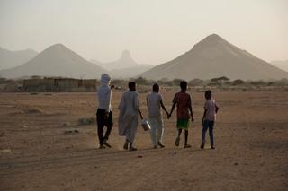 Sudanese children holding hands and walking together