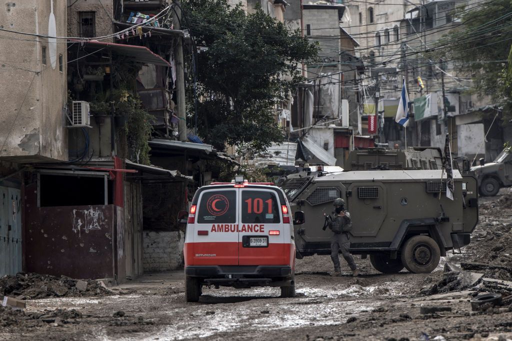 An Israeli soldier gestures towards a Palestinian Red Crescent ambulance at the entrance of the Tulkarem refugee camp in Tulkarem, in the occupied West Bank