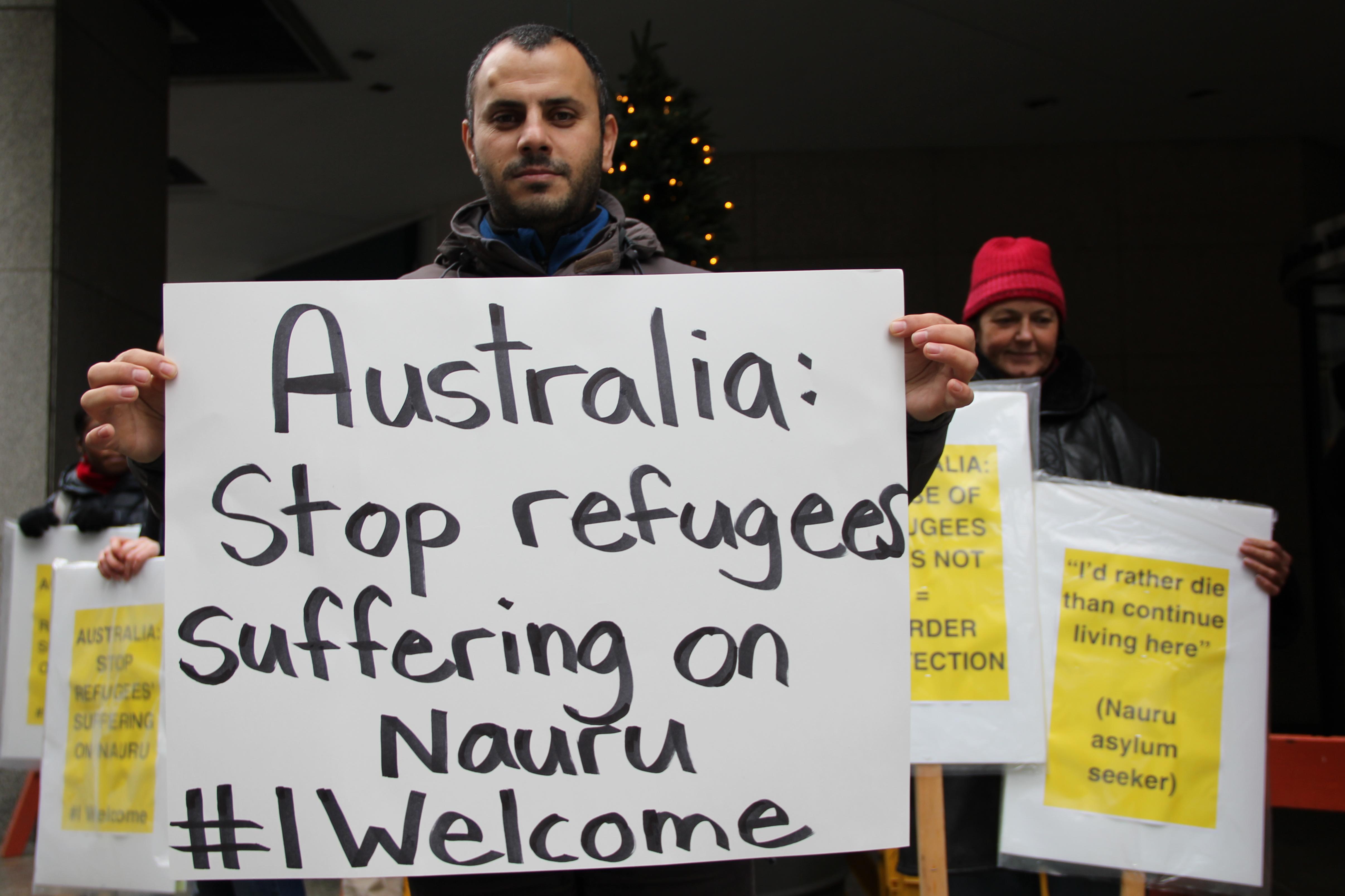 man holds protest sign