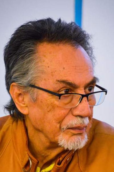 Juan Jacobo Hernández sits and looks off to the side.