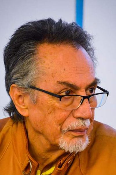 Juan Jacobo Hernández sits and looks off to the side.