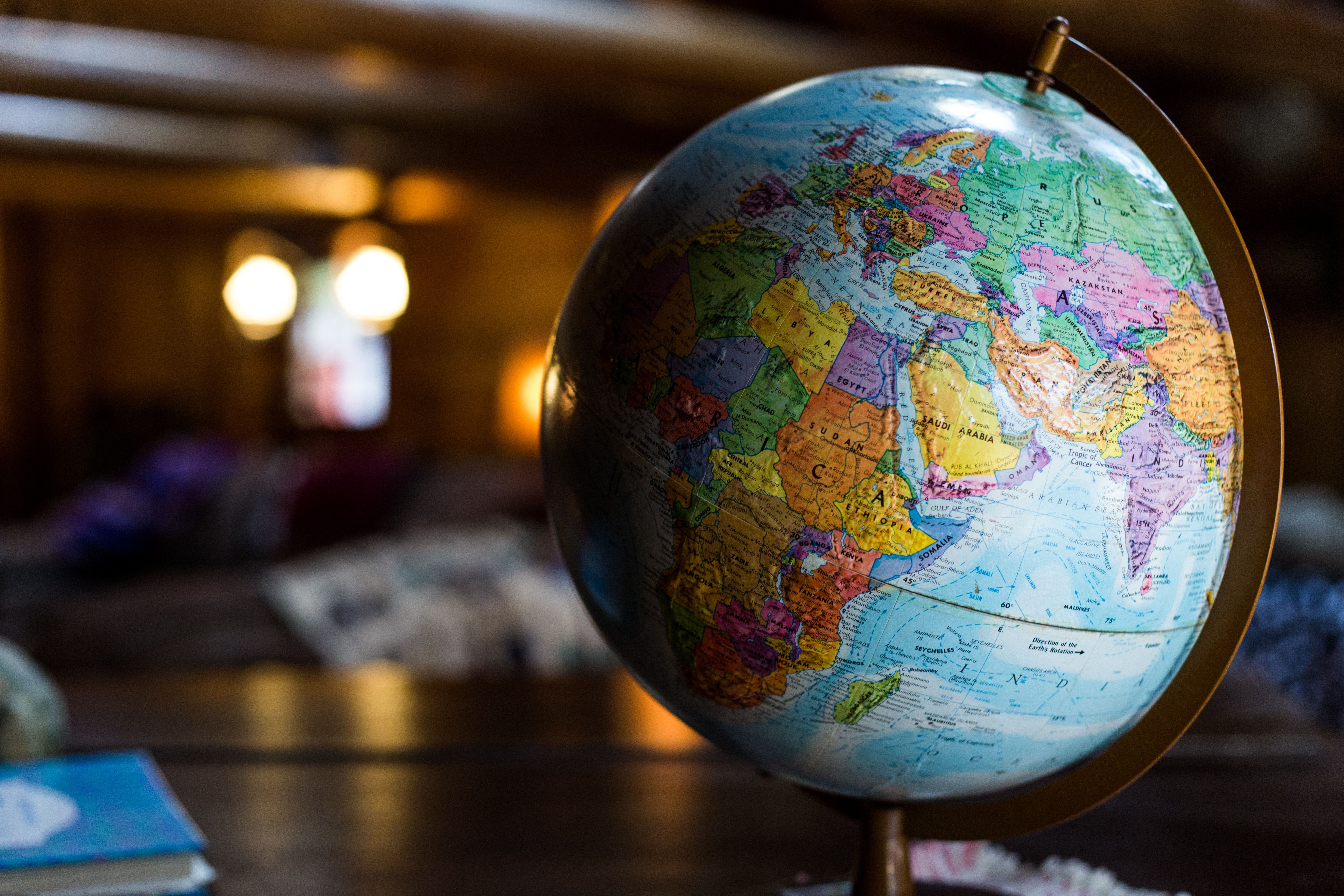 a globe on a desk with Saudi Arabia visible on the map