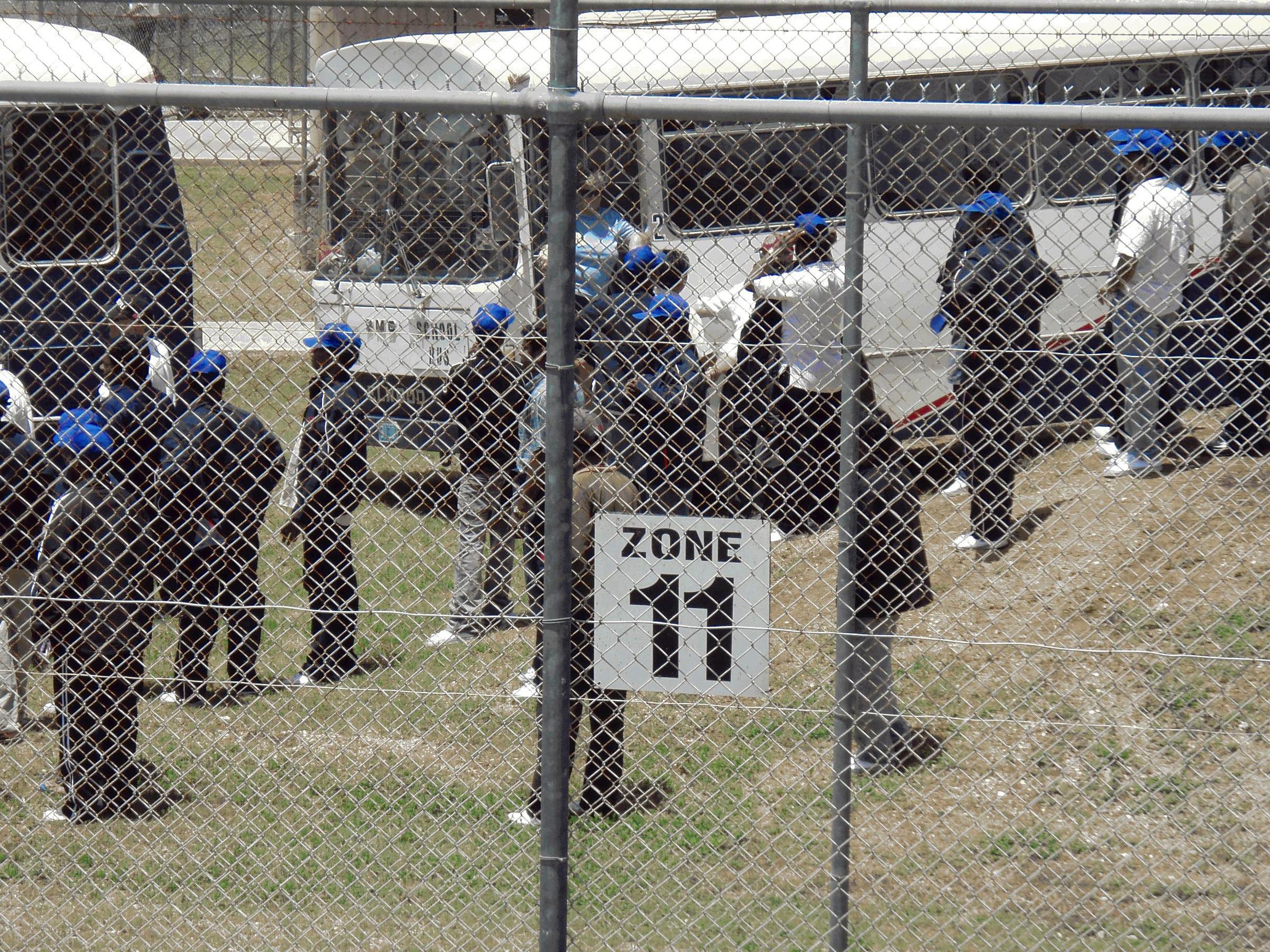 people wait in detention centre