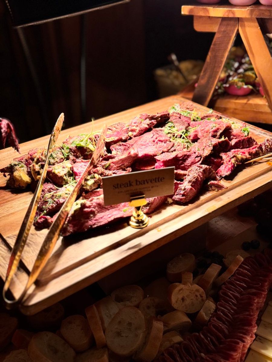 Steak bavette carved and ready to serve with gold tongs