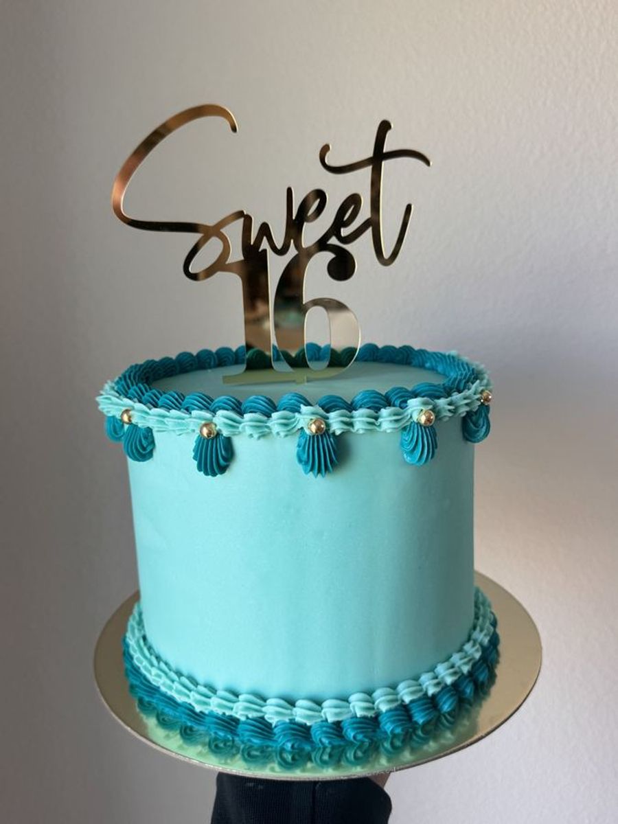 Teal celebration cake with piped detail