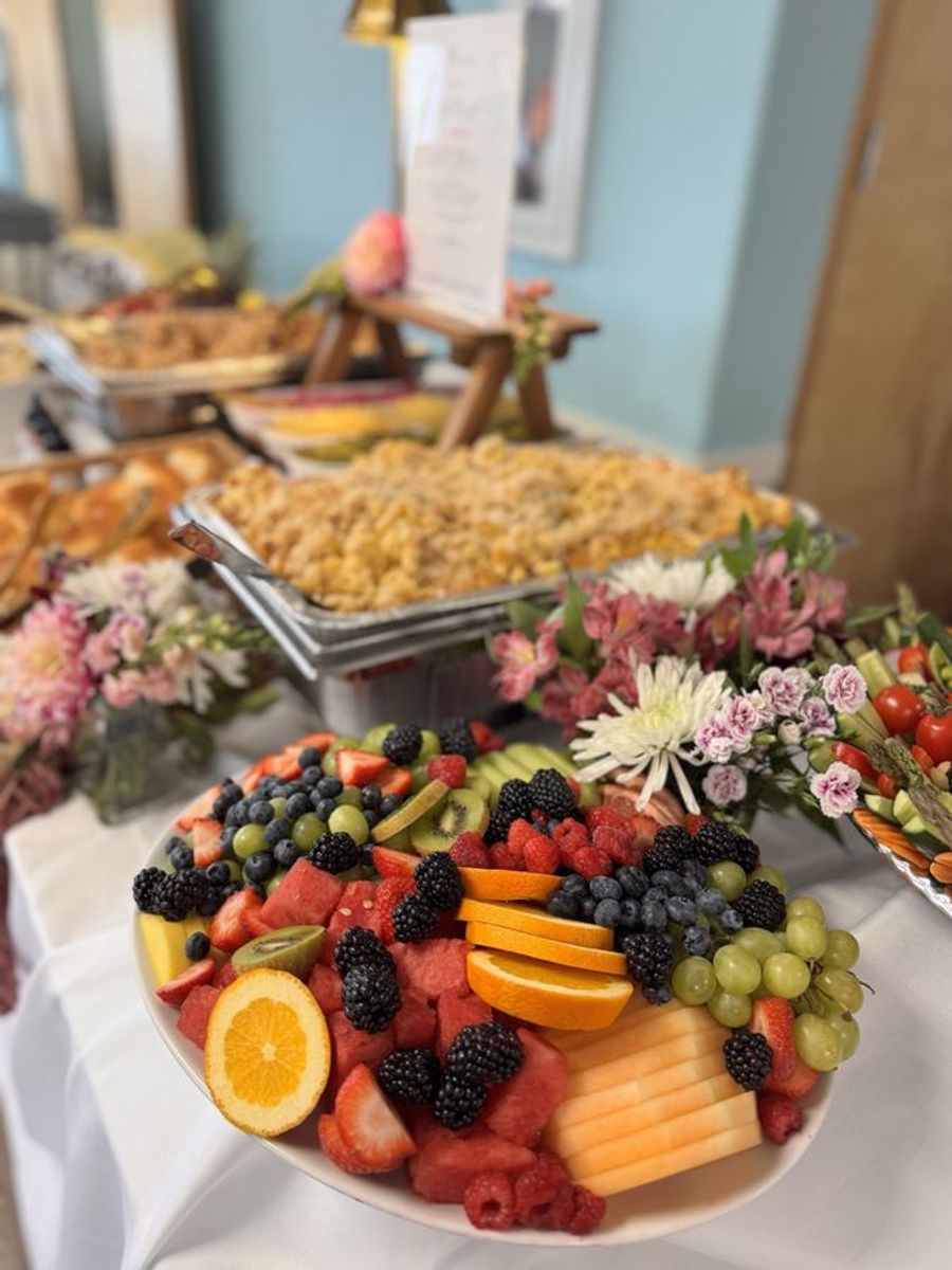 Fruit platter on the buffet line with fresh flowers