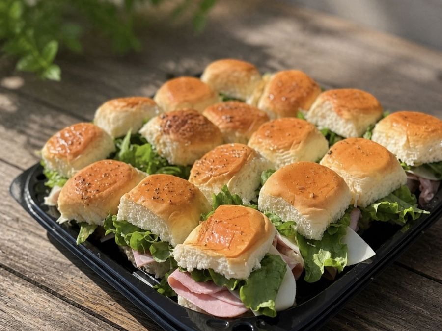Tray of sliders on lettuce, ready for pickup