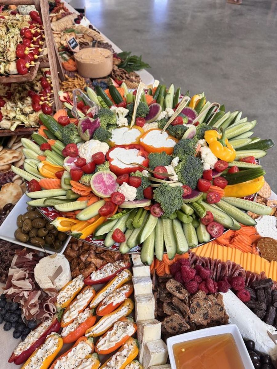 Charcuterie board with meats, cheeses, fruit, and crackers