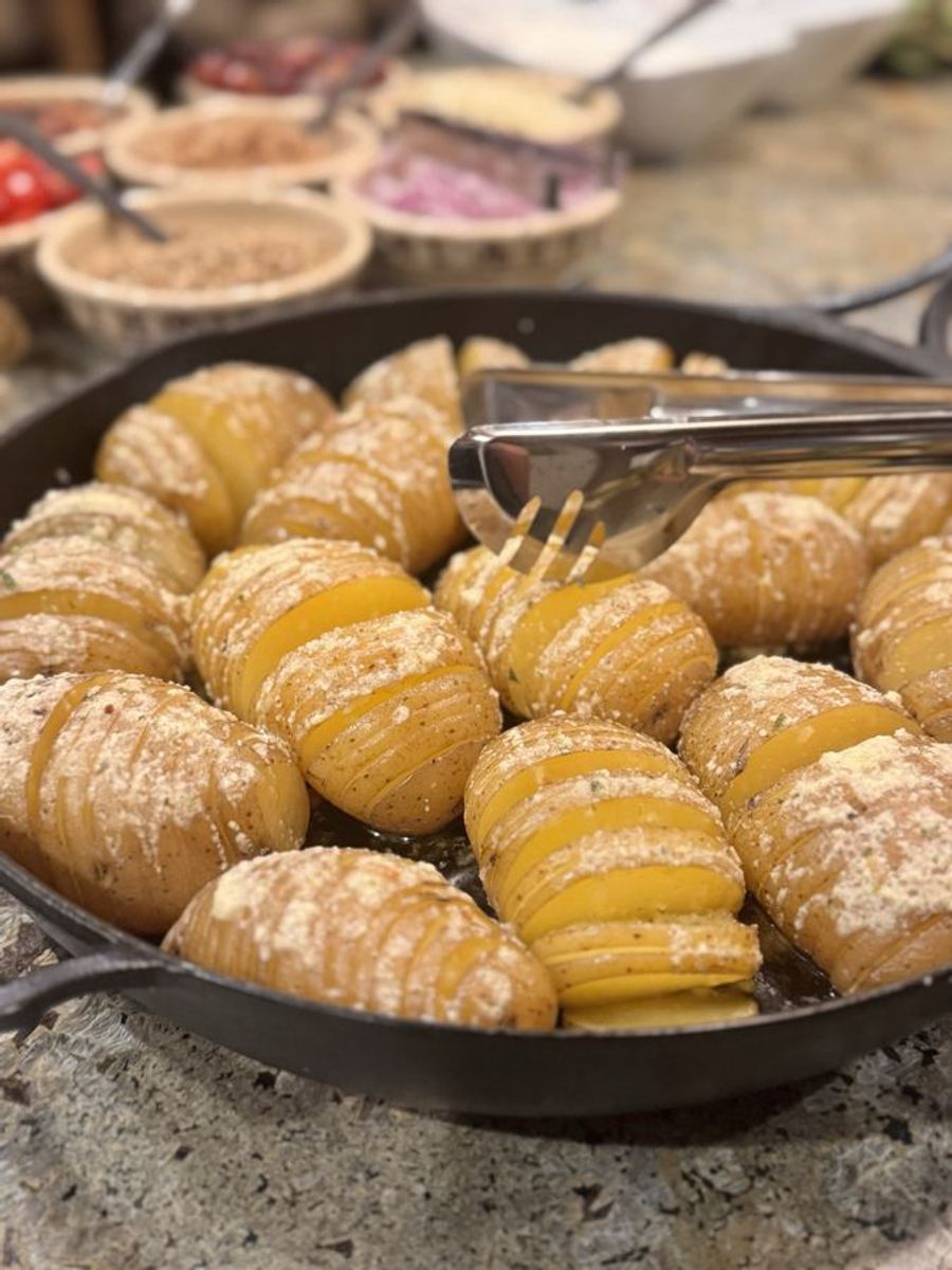 Hasselback potatoes in a cast iron pan