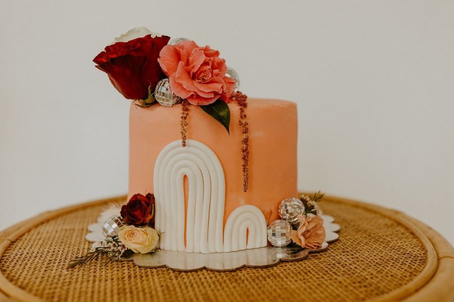 Peach coloured cake with an arch design