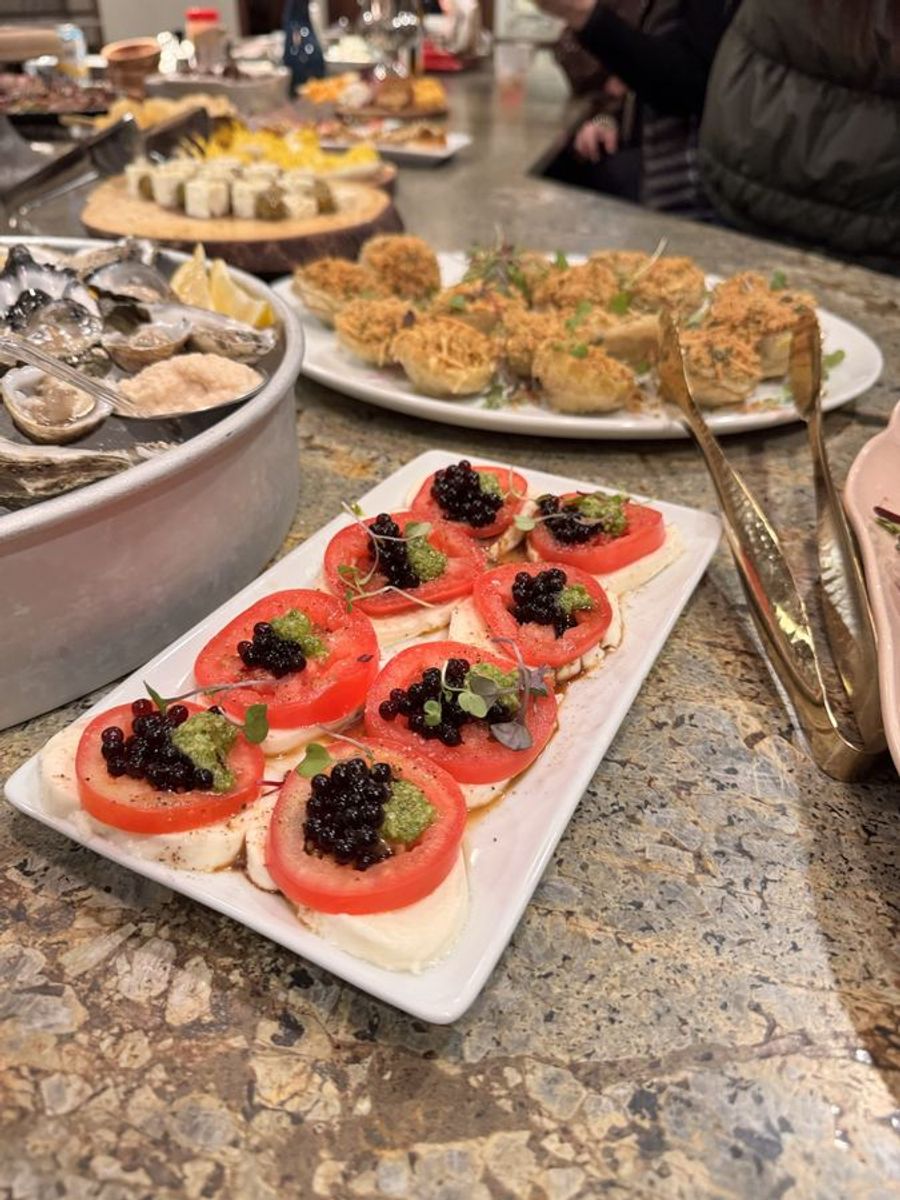Appetizer spread with caprese bites and oysters