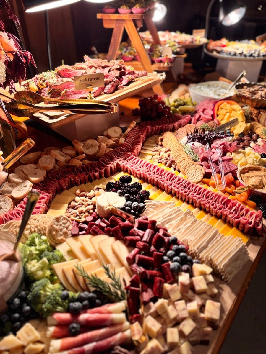 Close up of the grazing table with cured meats, cheeses, and berries