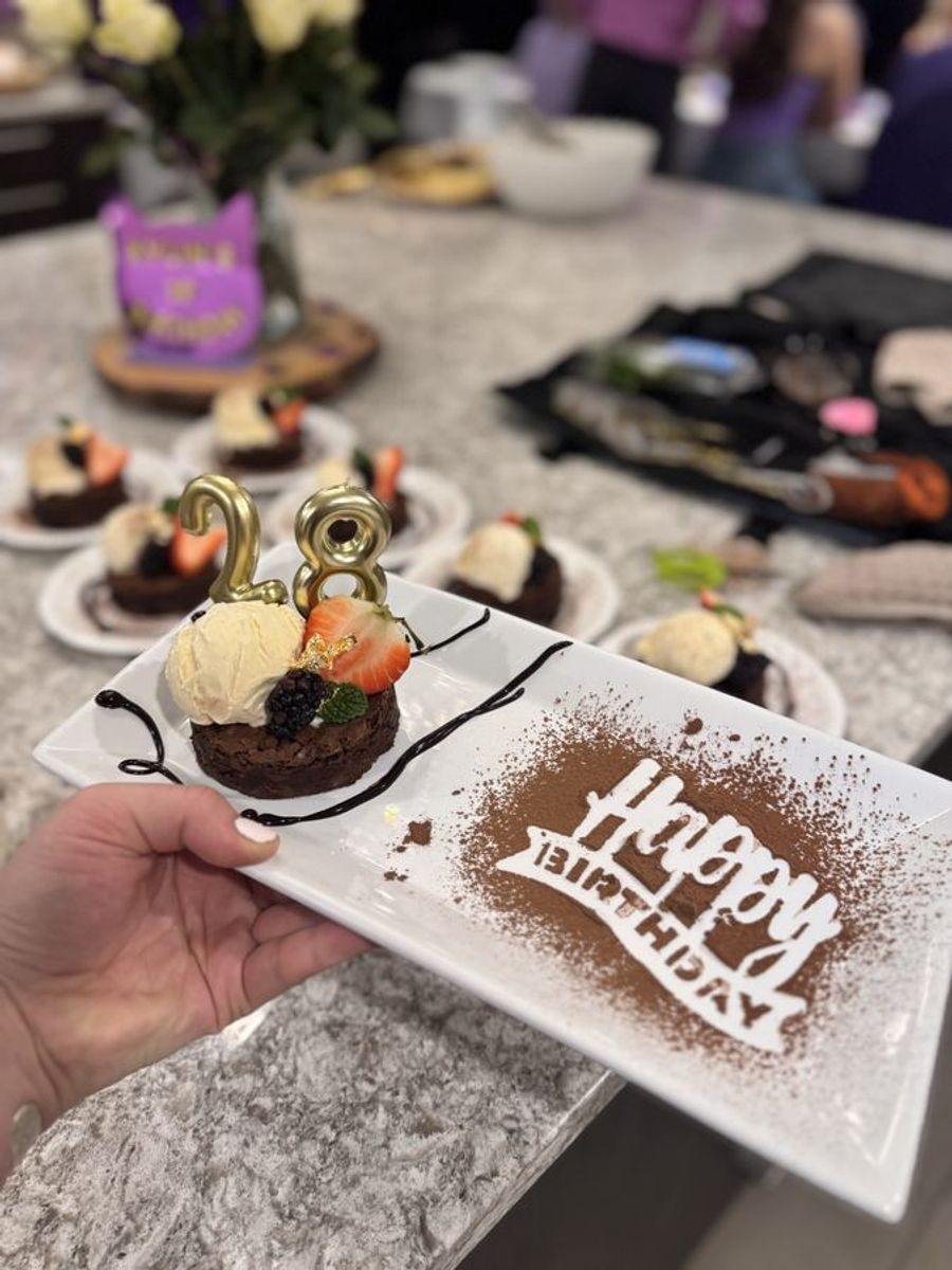 Birthday dessert plated with a happy birthday board