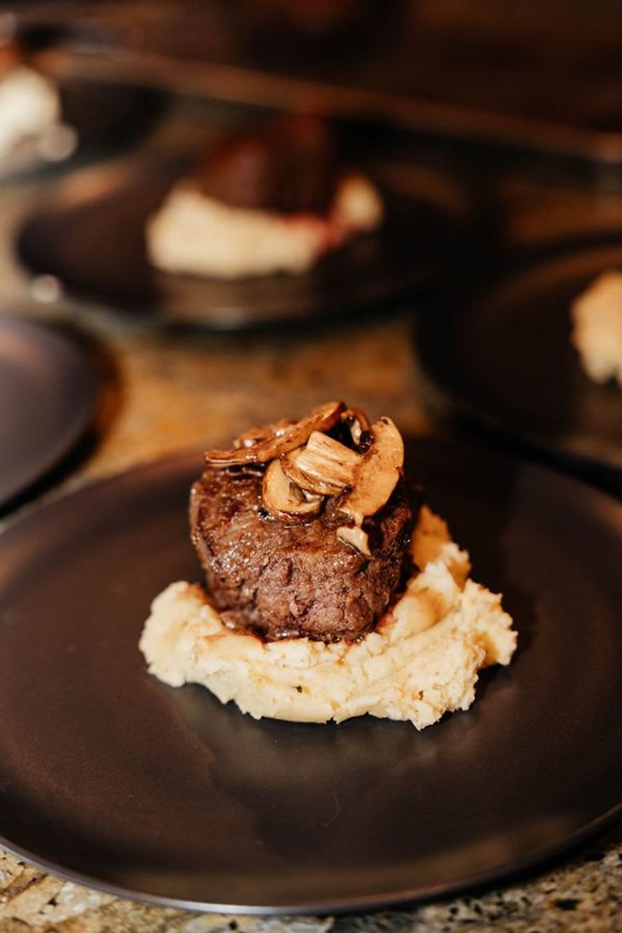 Seared filet over whipped potatoes with mushrooms