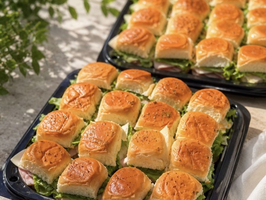 Two trays of sliders prepared for an order