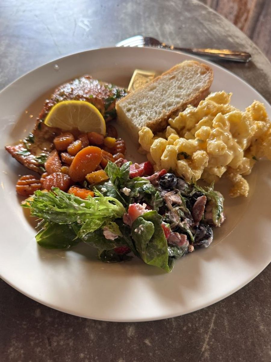 Plated salmon dinner with mac and cheese and berry salad