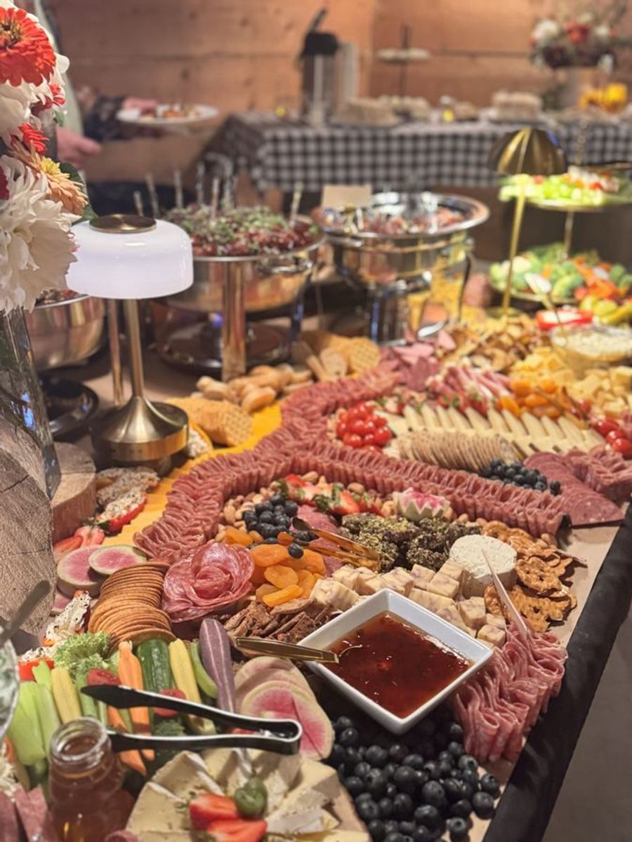 Long charcuterie table laid out for an event