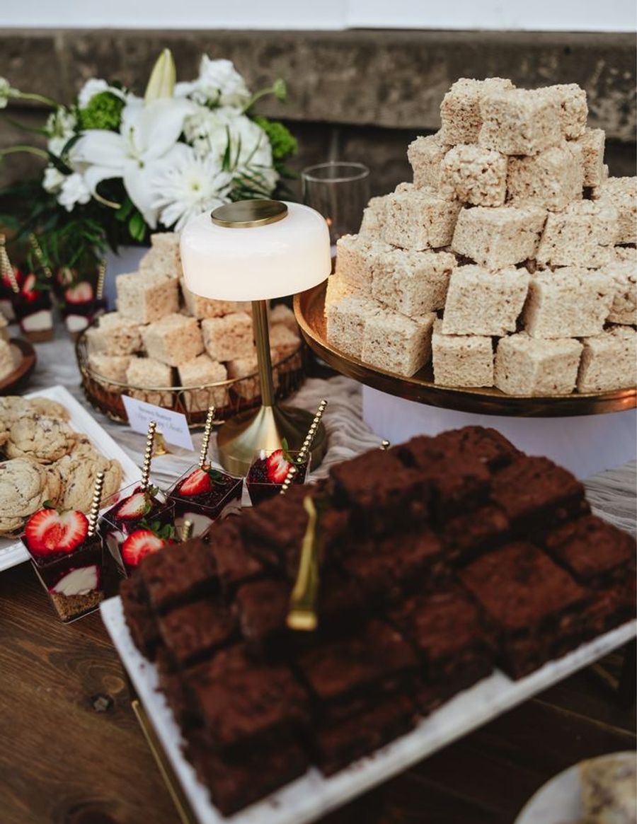 Dessert table with brownies and a tiered cake