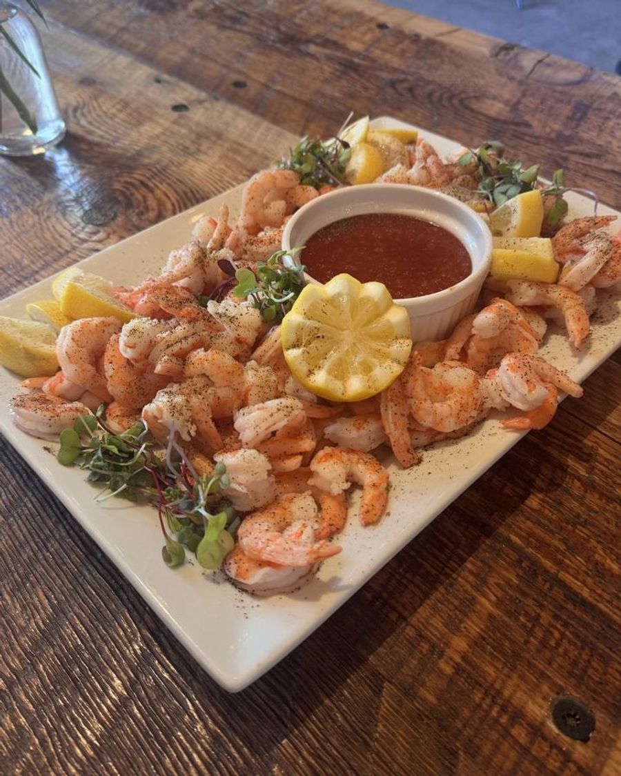 Shrimp cocktail platter with lemon and cocktail sauce