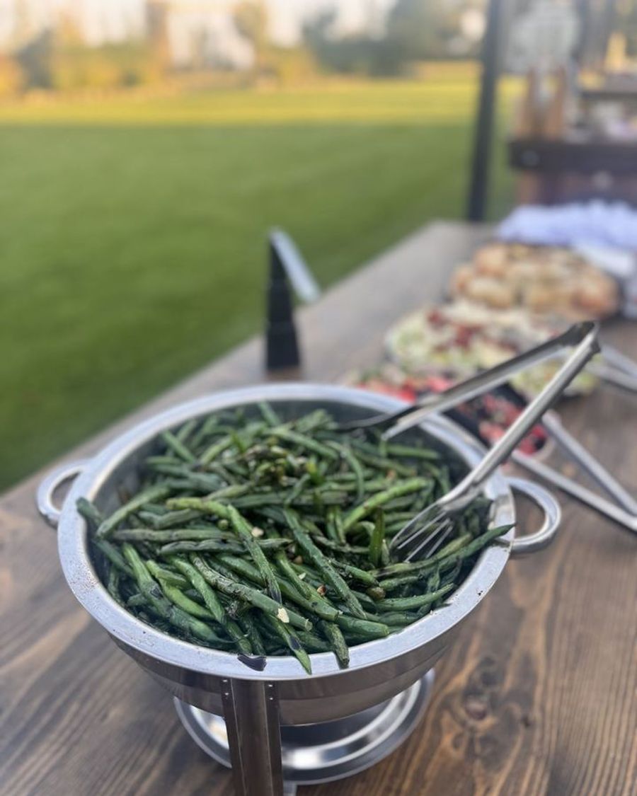 Green beans in a chafing dish at an outdoor event
