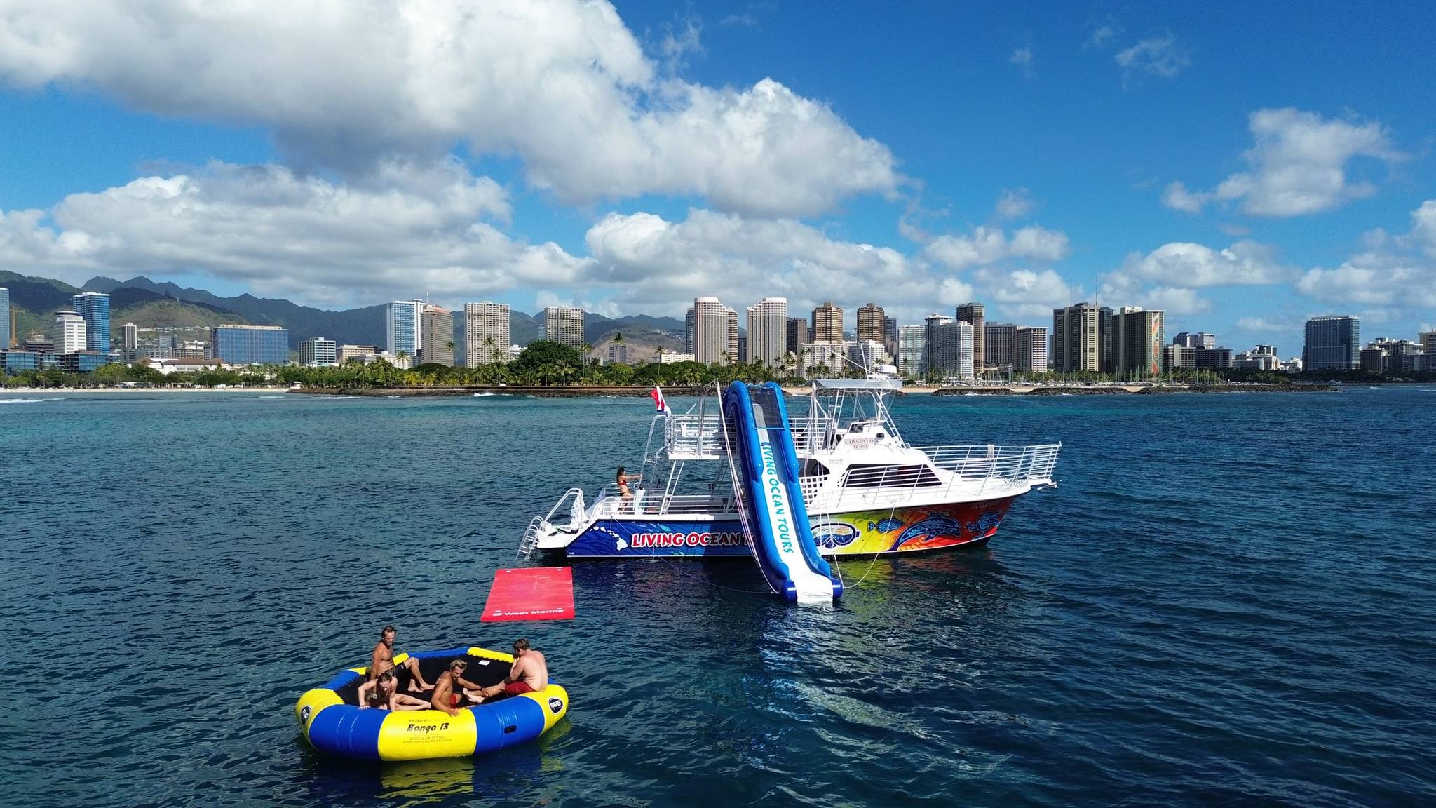 Living Ocean Tours boat with waterslide and trampoline off Waikiki