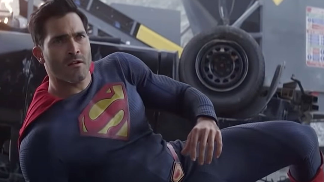 Superman is laying on the ground, looking confused.
