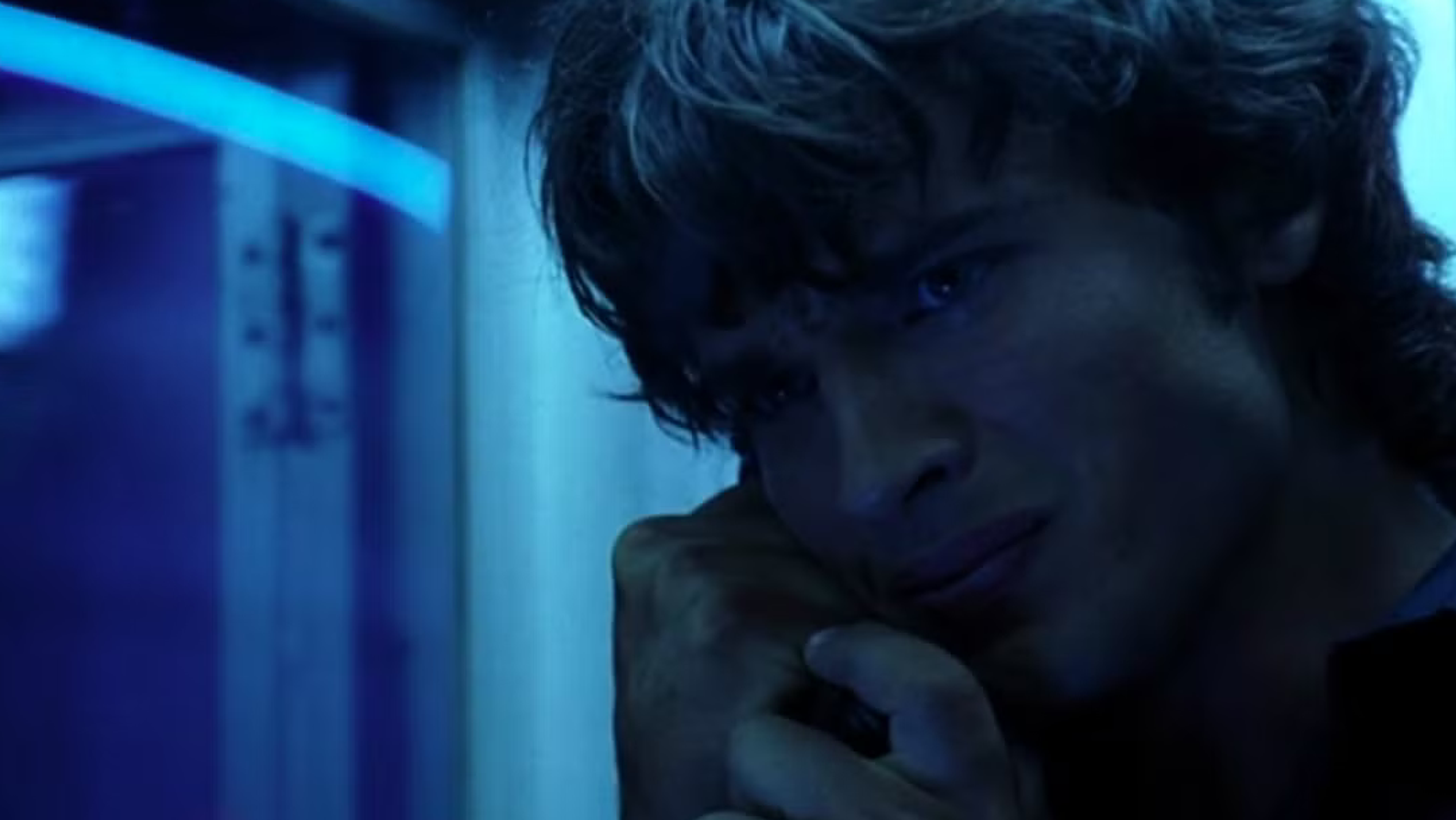 A young man looks conflicted about a phone call.