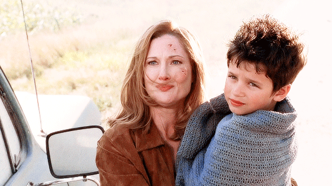 martha kent holding a young clark in a flashback.
