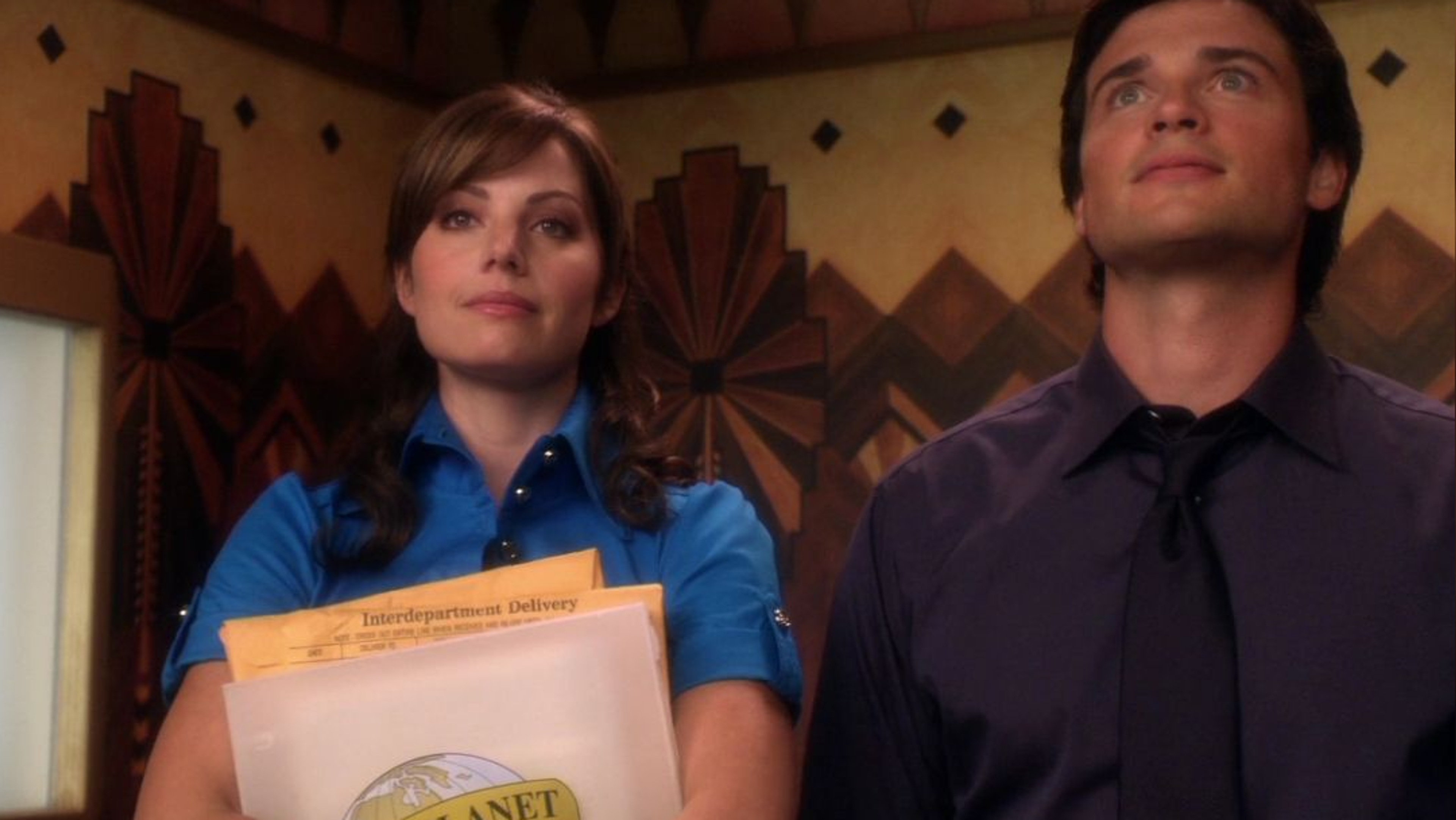 Lois and Clark awkwardly stand side by side in an elevator.